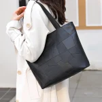 Sac à main pour femme en matériau PU au design à carreaux. Grande capacité. Convient aux voyages et à la photographie.