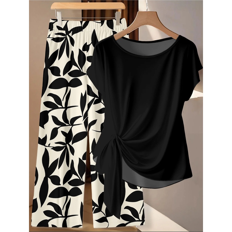 Ensemble deux pièces grande taille pour femmes, style décontracté, t-shirt noir à torsades latérales et pantalon large à imprimé feuilles noir et blanc, tenue décontractée