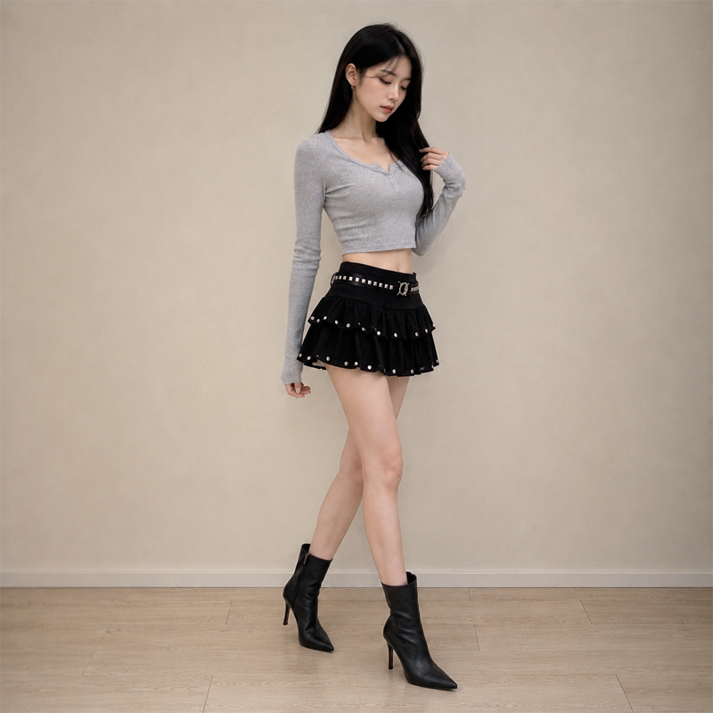 Mini-jupe noire taille basse à volants pour femme, avec ourlet superposé et détails cloutés, style Y2K streetwear, mignonne et décontractée