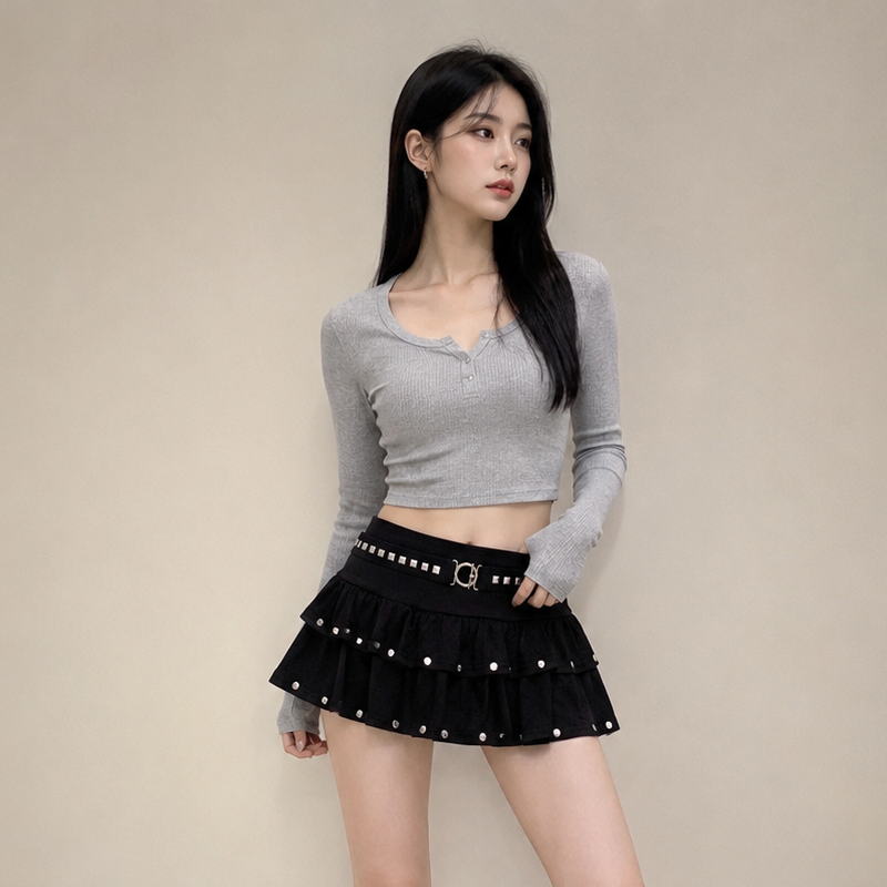 Mini-jupe noire taille basse à volants pour femme, avec ourlet superposé et détails cloutés, style Y2K streetwear, mignonne et décontractée