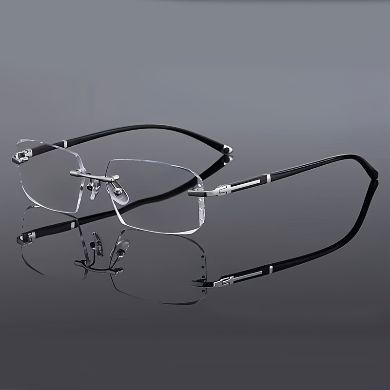 Des lunettes de soleil élégantes, unisexes, sans monture, à verres plats et transparents, au design rectangulaire, pour un usage décontracté.