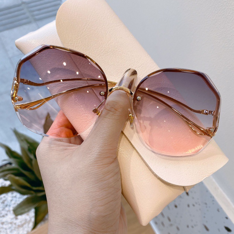 Lunettes de soleil de luxe UV400 pour femmes, verres d'océan, sans bords, branches incurvées en métal, unisexe