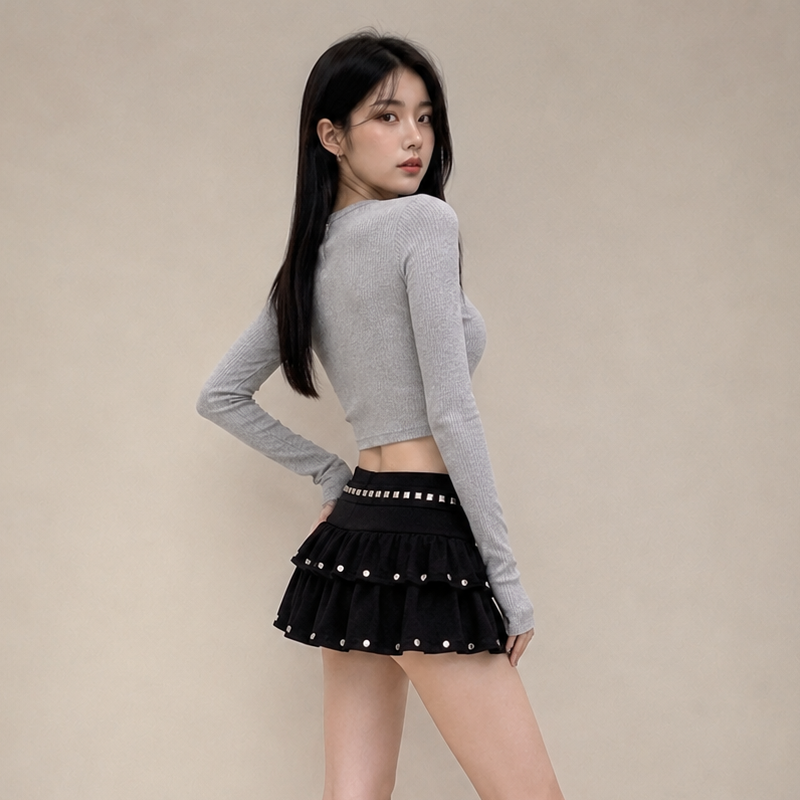 Mini-jupe noire taille basse à volants pour femme, avec ourlet superposé et détails cloutés, style Y2K streetwear, mignonne et décontractée