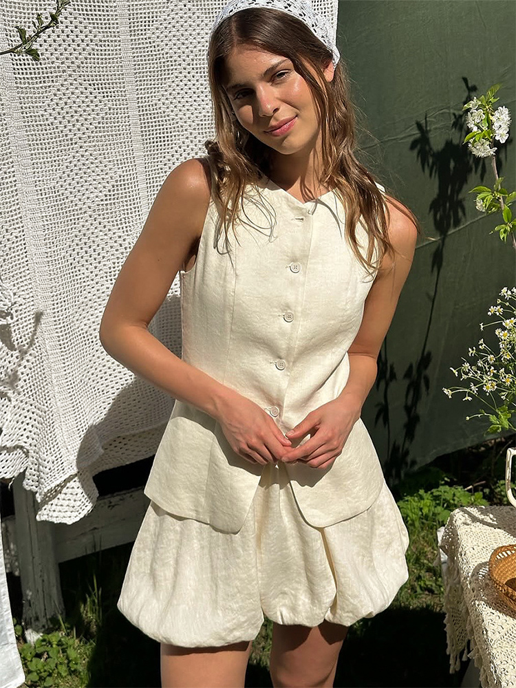 Ensemble 2 pièces pour femme en coton, été 2026, chic et décontracté pour le travail, comprenant un débardeur sans manches et une jupe courte à volants, tenue décontractée pour femme.