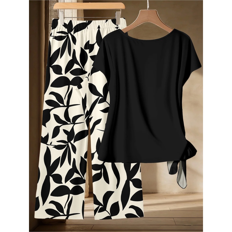 Ensemble deux pièces grande taille pour femmes, style décontracté, t-shirt noir à torsades latérales et pantalon large à imprimé feuilles noir et blanc, tenue décontractée